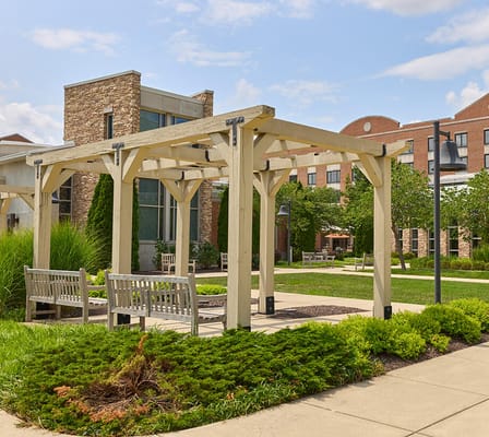 Outdoor seating area with pergola and greenery