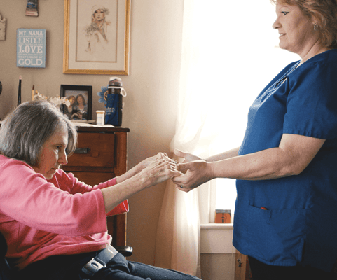 Caregiver assisting a senior resident indoors