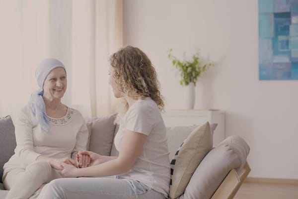 A caregiver and resident having a conversation in a cozy living room