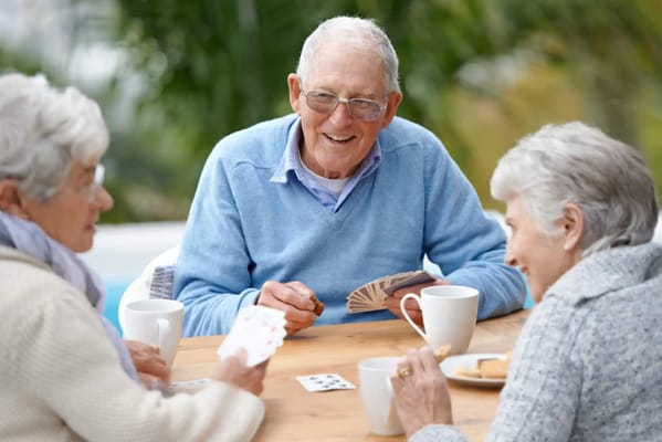 Seniors enjoying a card game outdoors