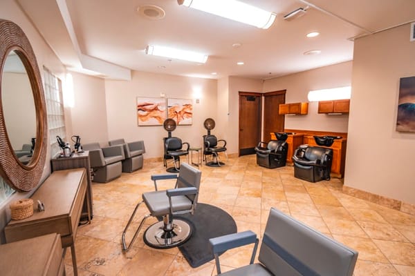 Bright salon space with styling chairs and equipment