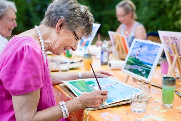 Senior resident painting in an art class