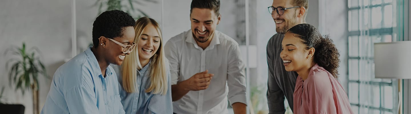 Group of diverse people smiling in a bright interior