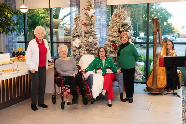 Residents and staff celebrating in a decorated common area