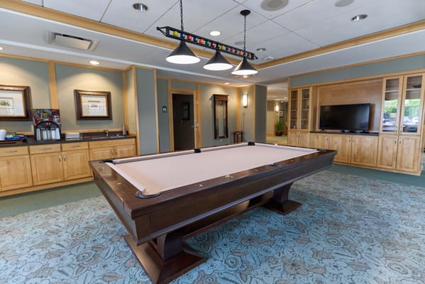 Common area with a pool table and seating.