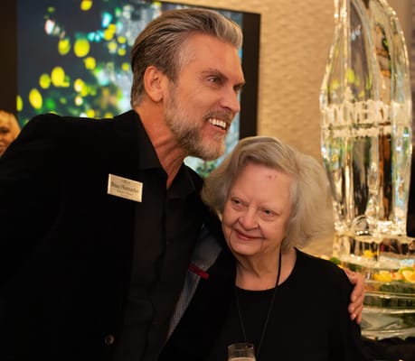 Staff member with a resident at a celebration event