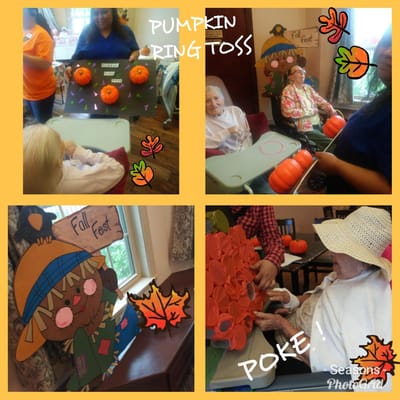 Residents participating in a fall festival ring toss activity