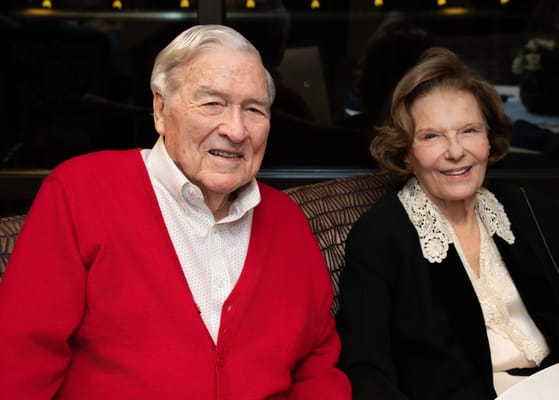 Two smiling residents sitting together in a cozy setting