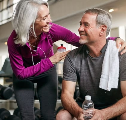 Two residents enjoying a workout together in a gym