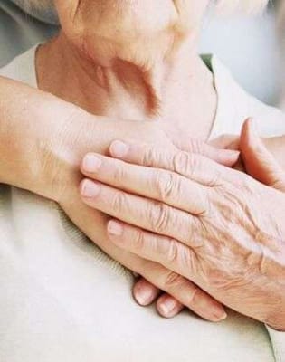 Close-up of an elderly person's hands being held