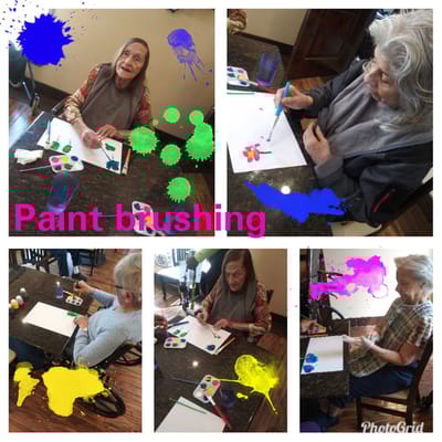Residents engaged in a paint brushing activity