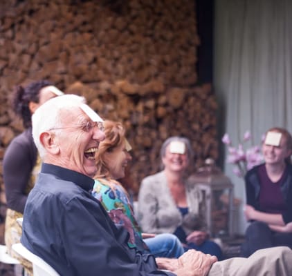 Residents enjoying a laughter-filled group activity indoors
