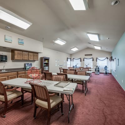 Bright activity room with tables and chairs