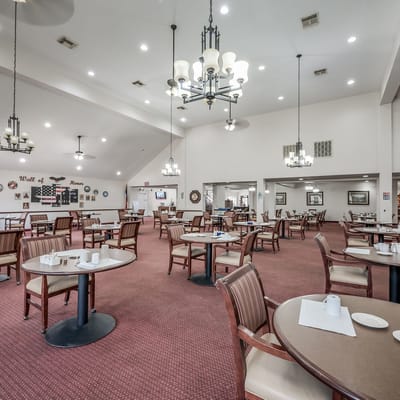 Spacious dining room with tables and chairs arranged