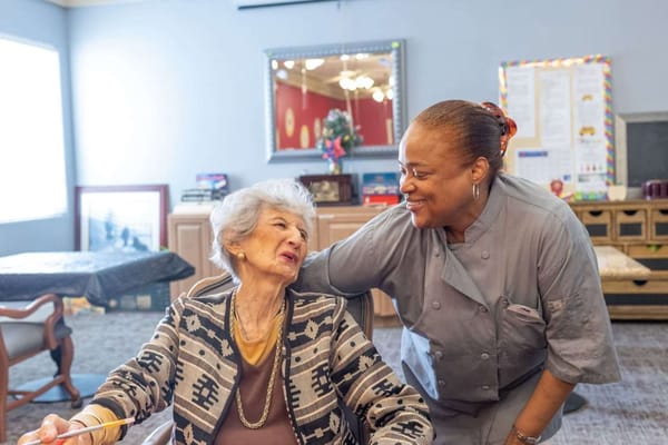 A caregiver interacting with a resident in a common area