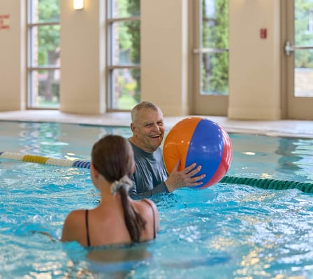 Residents enjoying a water activity in the pool