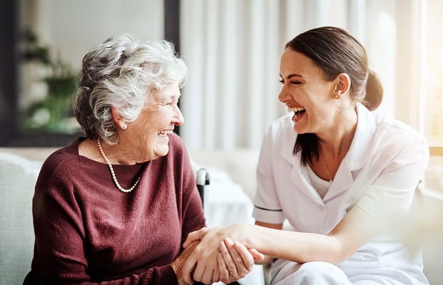 A caregiver and a resident sharing a joyful moment