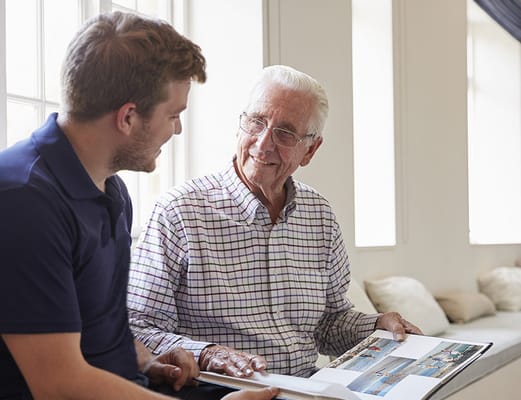 Senior resident engaged in conversation with staff member