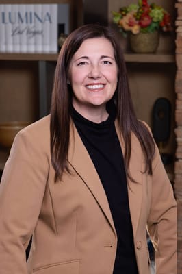 A staff member smiling in a facility setting