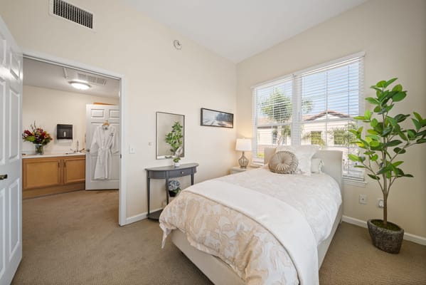 Bright, well-decorated resident room with natural light