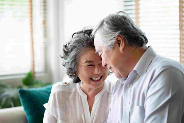 A happy couple enjoying time together in a bright common area