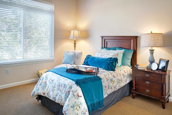 Cozy bedroom with floral bedding and natural light