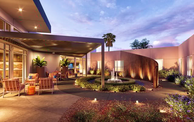 Outdoor seating area with gardens and fountain