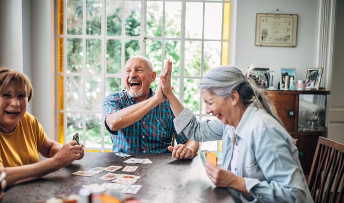 Residents enjoying a game of cards in a common area