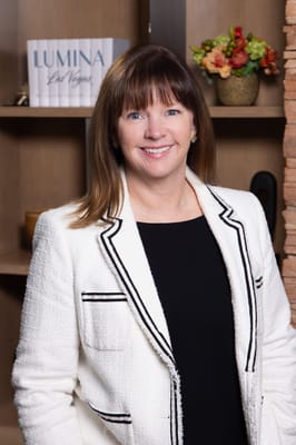 Staff member smiling in a bright interior setting