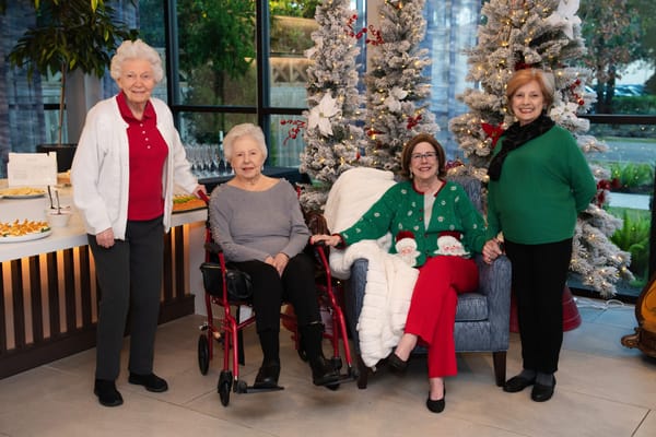Residents and staff celebrating in a decorated common area