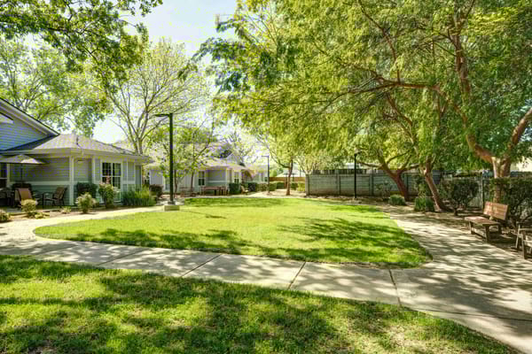 Outdoor courtyard with lush greenery and walking paths