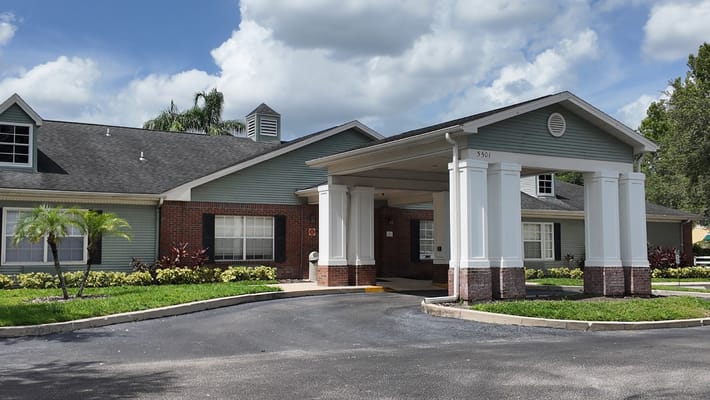 Front entrance of a senior living facility with a covered entryway