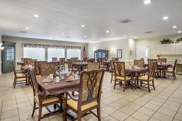 Dining area with tables and chairs set up for meals