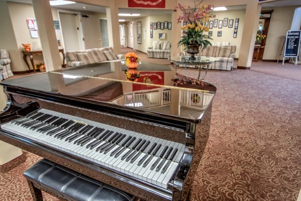 Close-up of a grand piano in the lobby of The Hampshire Senior Living Community