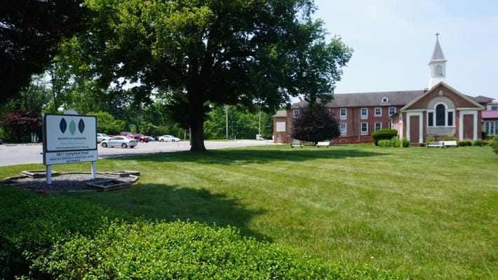 Outside view of Resorts of Augsburg facility with landscaping.