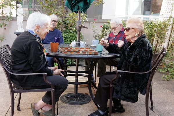Residents enjoying a game outdoors in a sunny setting
