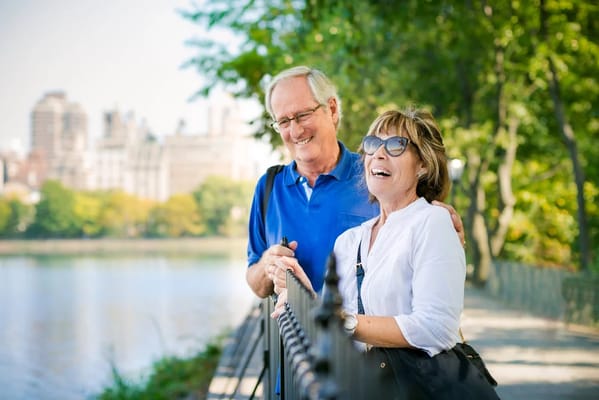 Happy seniors enjoying a walk by the lake