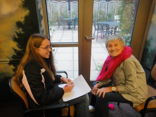 A resident with a visitor in a courtyard