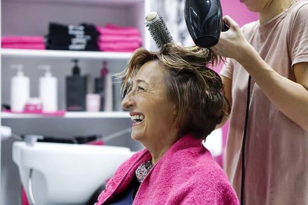 A resident enjoying a hair salon treatment