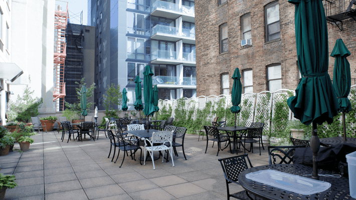 Outdoor patio area with tables and umbrellas