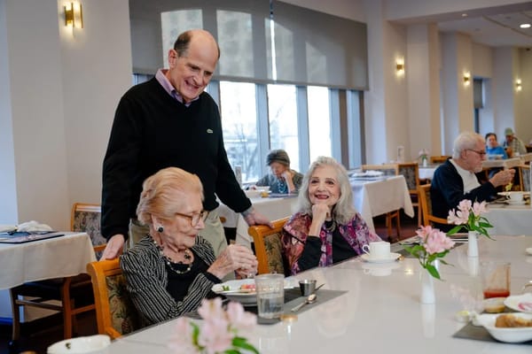 Seniors enjoying a meal in a bright dining room