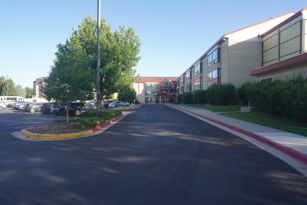 Entrance view of a senior living facility with trees