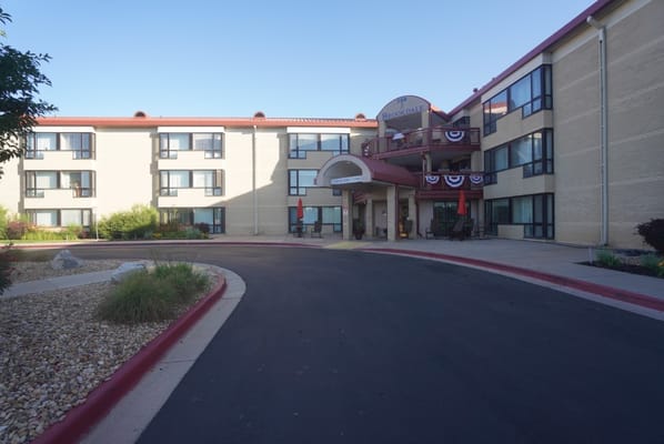 Exterior view of a senior living facility with landscaped entrance