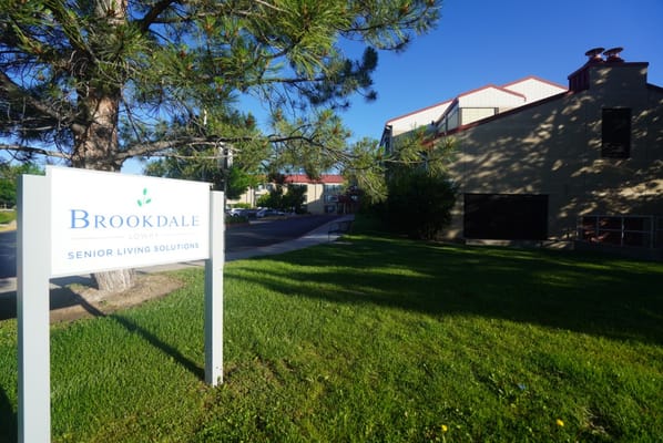 Exterior view of a senior living facility with signage