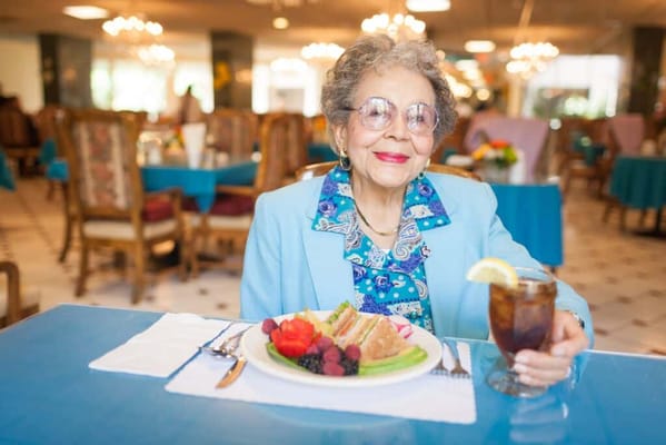 Resident enjoying a meal in the dining room