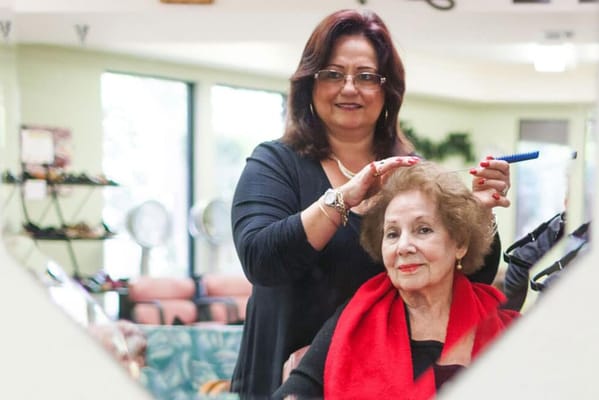 A resident getting their hair styled in a salon