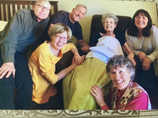 Residents and staff gathered together, smiling