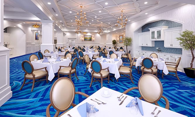 Elegant dining room with tables set for residents