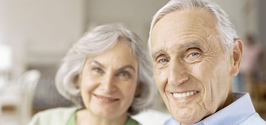 Smiling elderly couple posing for a photo