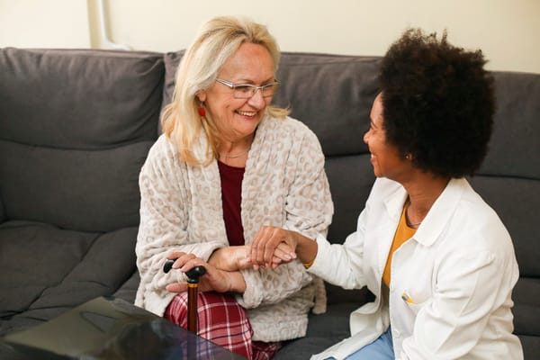 Staff member interacting with a resident in a cozy living room
